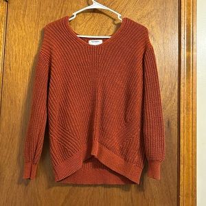 reddish orange sweater